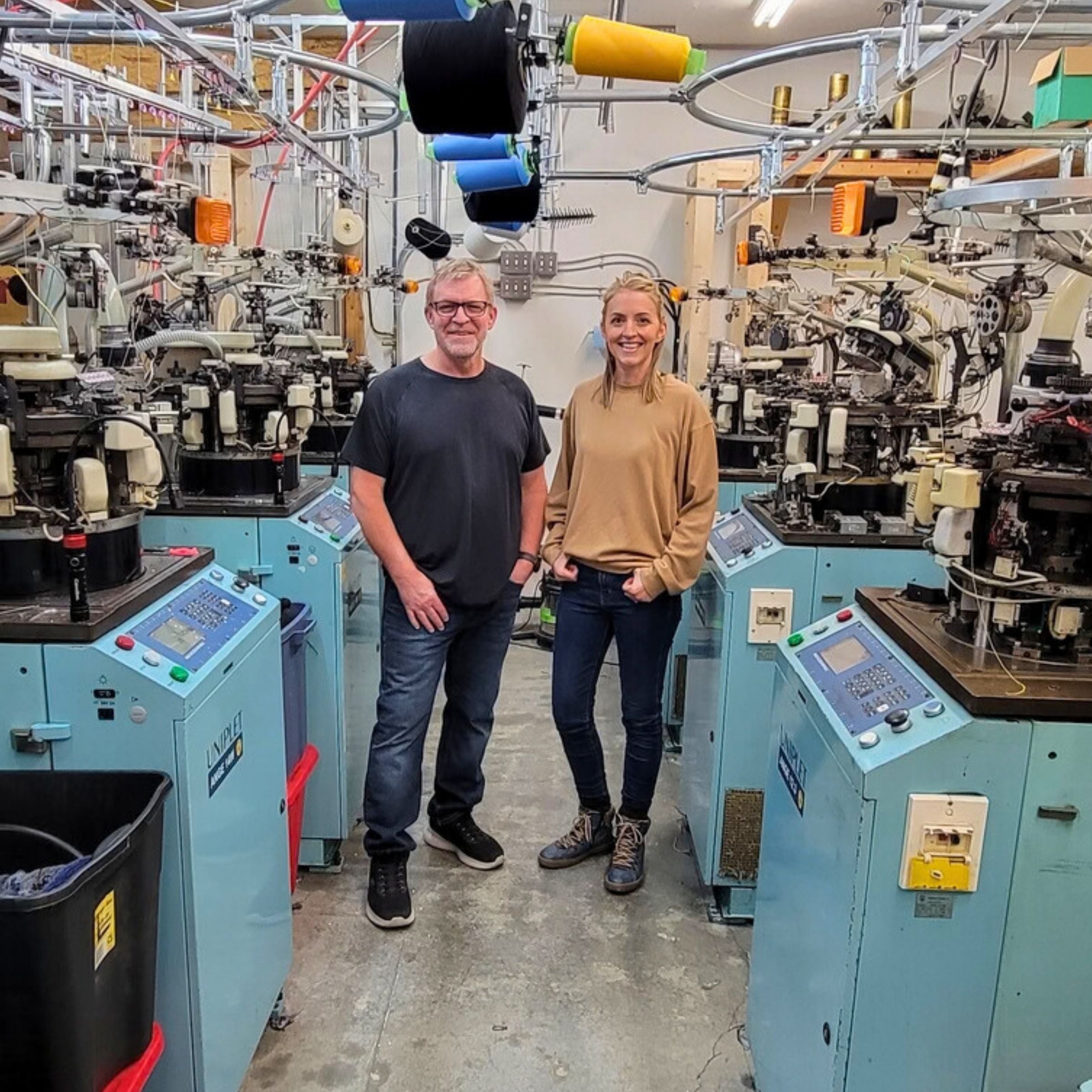 Sean Gallant and his daughter Robyn Phelan standing in their sock machine shop.